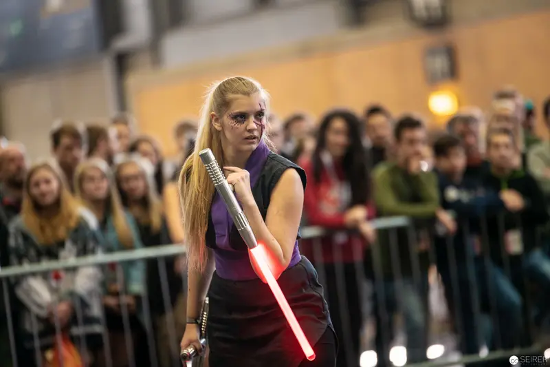 Cosplayer with Illuminated Lightsaber at Vienna ComicCon 2018 Fan Convention