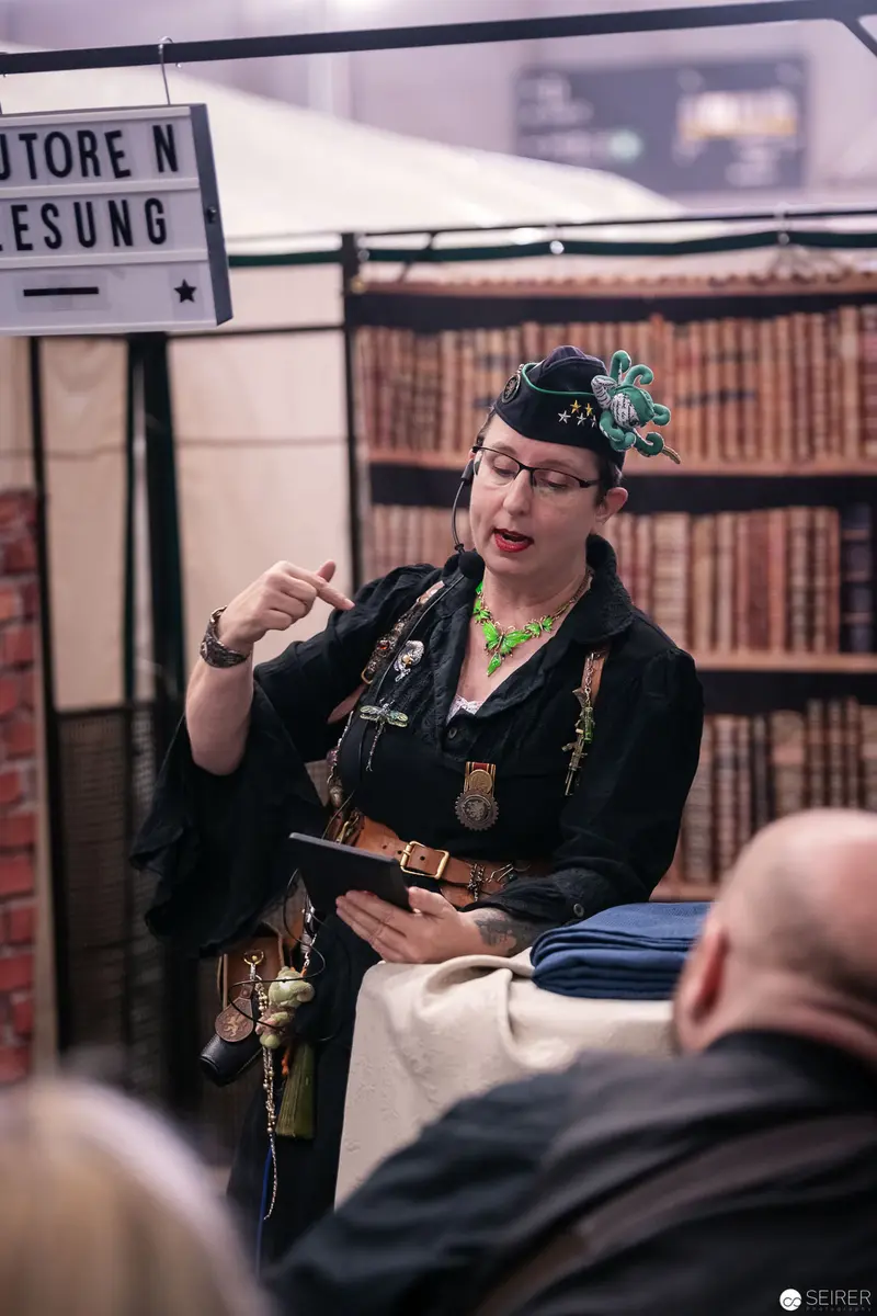 Costumed Performer Presenting at Vienna ComicCon 2018 Book Display