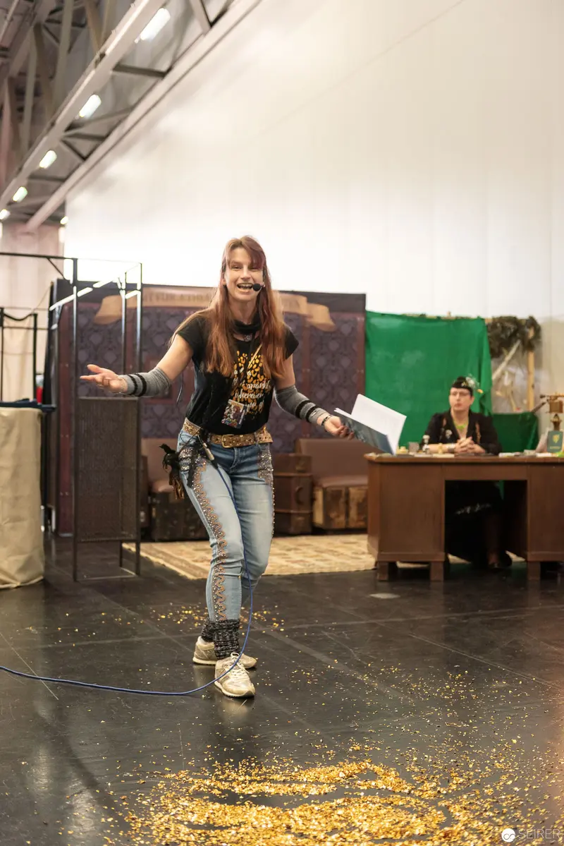 Performer Stands Amid Scattered Glitter on Stage During Theater Production Rehearsal