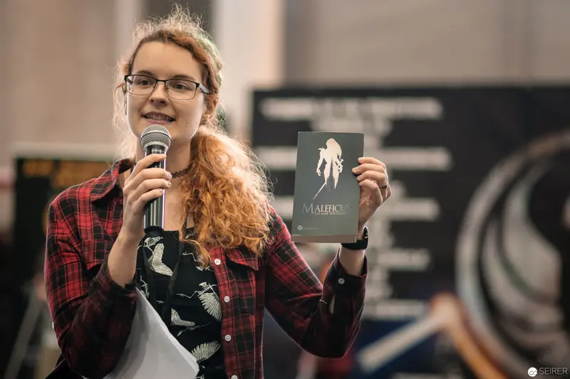 Speaker Presenting Book at Vienna ComicCon 2018 with Microphone and Publication
