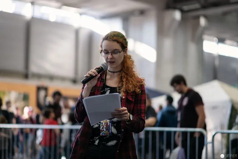Speaker Performing at Vienna ComicCon 2018 with Microphone and Manuscript