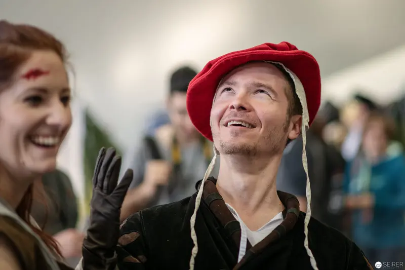 Joyful Costumed Attendee in Red Hat at Vienna ComicCon 2018