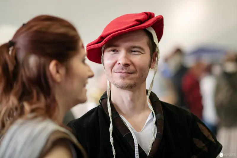 Attendee in Distinctive Red Hat at Vienna ComicCon 2018 Shares Warm Interaction