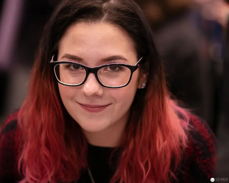 Young Woman with Red Ombré Hair and Black-Rimmed Glasses at VIECC 2018