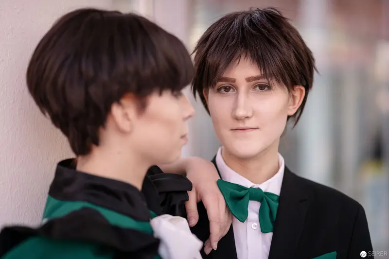 Two Cosplayers in Matching Green and Black Attire at VIECC 2018