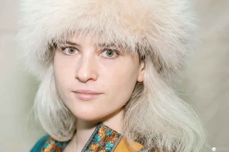 Winter Fashion Portrait with Fur Hat and Colorful Embroidered Jacket