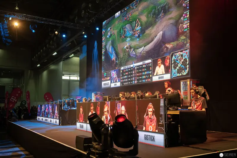 eSports Tournament Stage at Gaming Competition with Large Video Game Screen Display