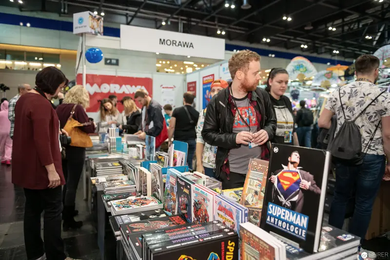Morawa Comic Book Booth at Vienna Comic Con, Visitors Browsing Graphic Novel Displays