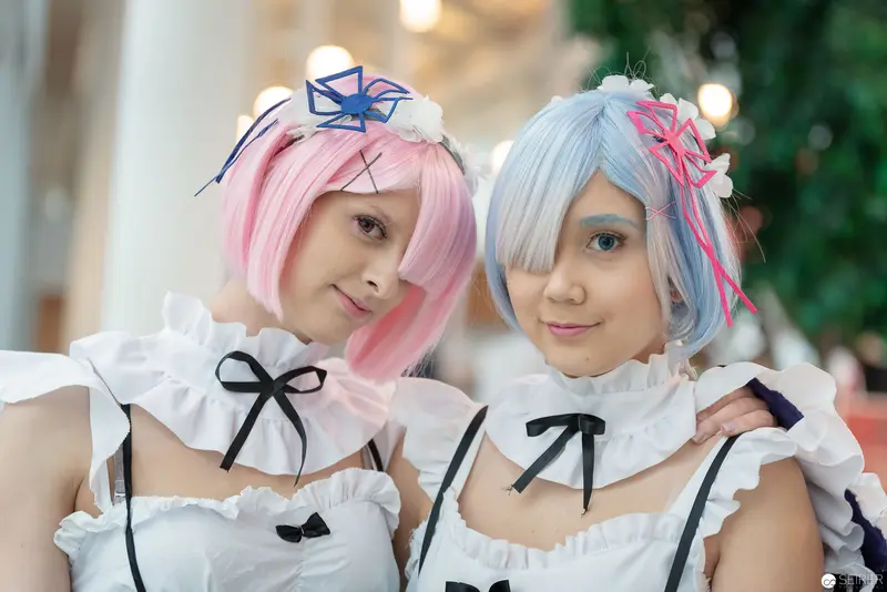 Cosplay Duo in White Ruffles: Anime Character Portrayal at VIECC 2018