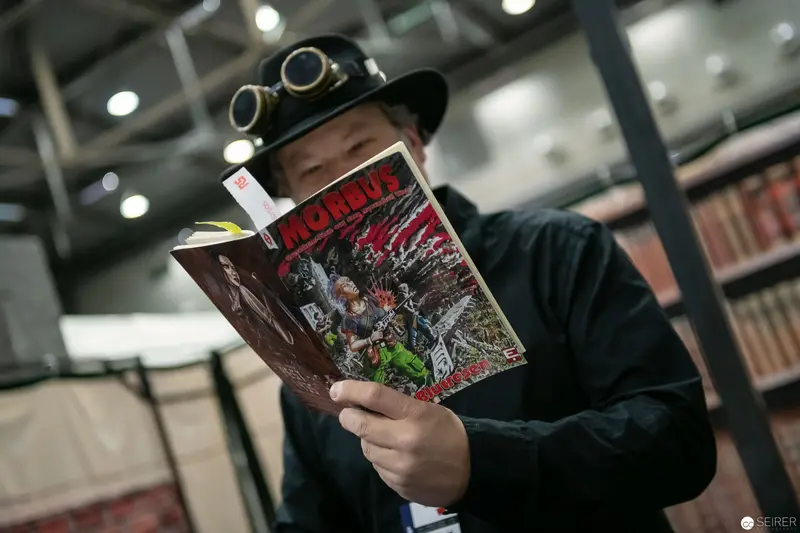 Steampunk Reader Engrossed in Comic Book at VIECC 2018 Comic Convention