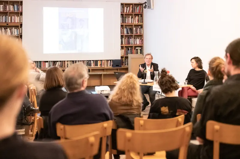 Public Lecture in Academic Library with Presenters at Podium