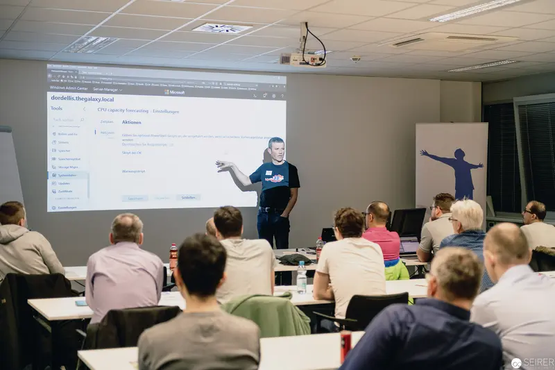 Software Training Workshop: Instructor Presenting Digital Interface to Seated Audience