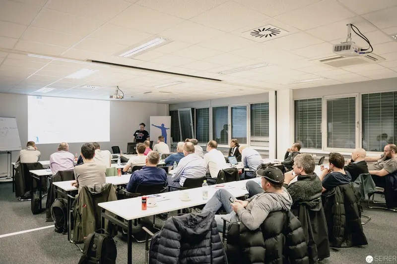 Professional Workshop with Instructor Presenting to Seated Audience in Corporate Training Room