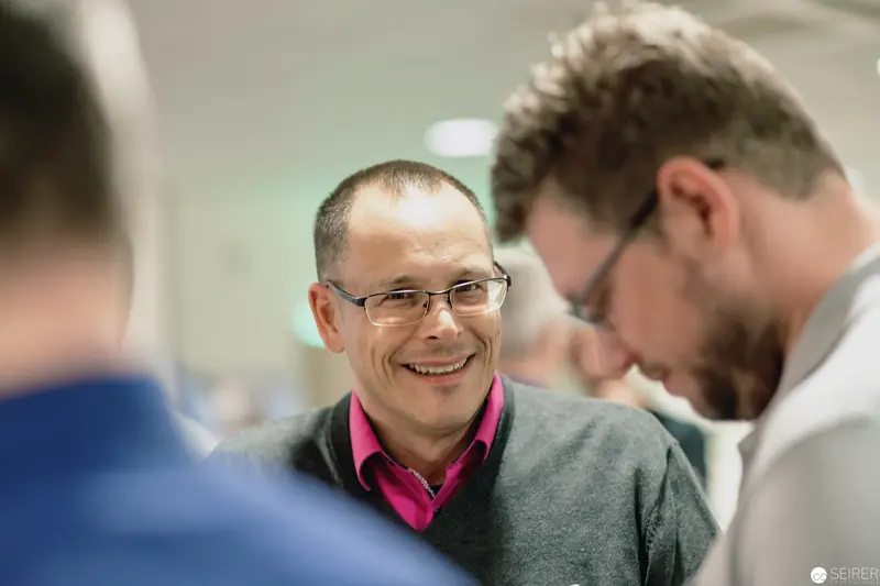 Professional Colleagues Sharing a Moment of Warmth in Workplace Interaction