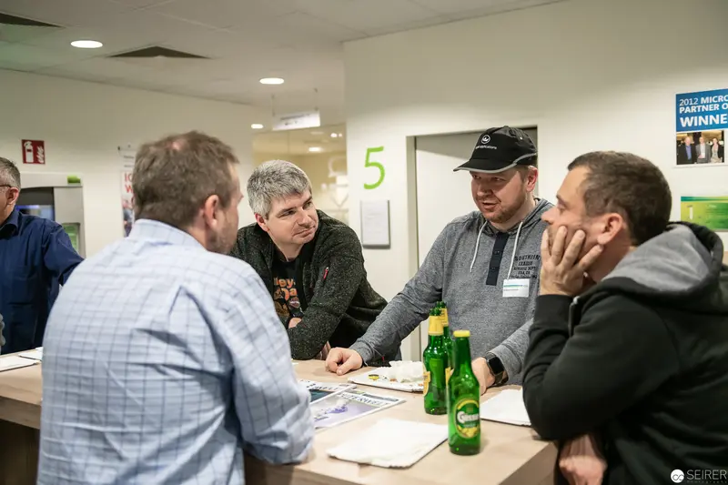 Business Meeting with Green Bottles at Informal Conference Table