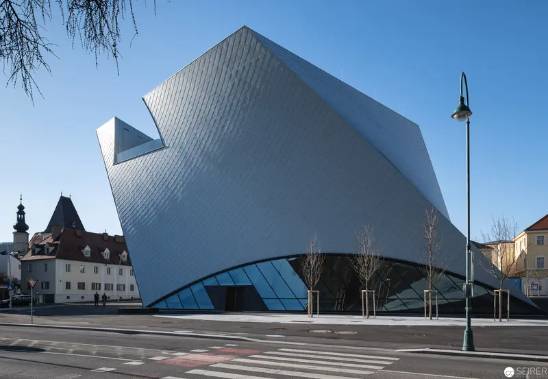 Modern Crystalline Museum Structure with Angular Metallic Facade in Historic Urban Setting
