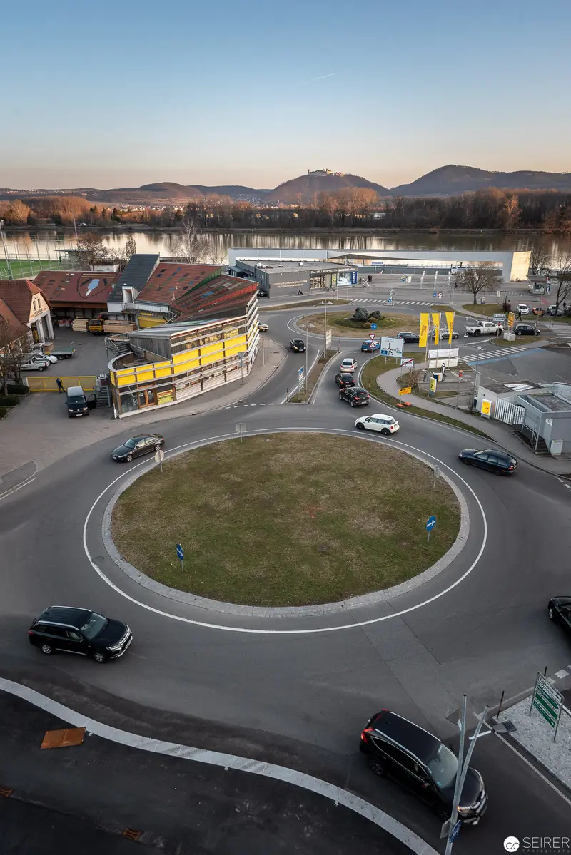 European Urban Roundabout with Circular Traffic Management and Mountain Backdrop