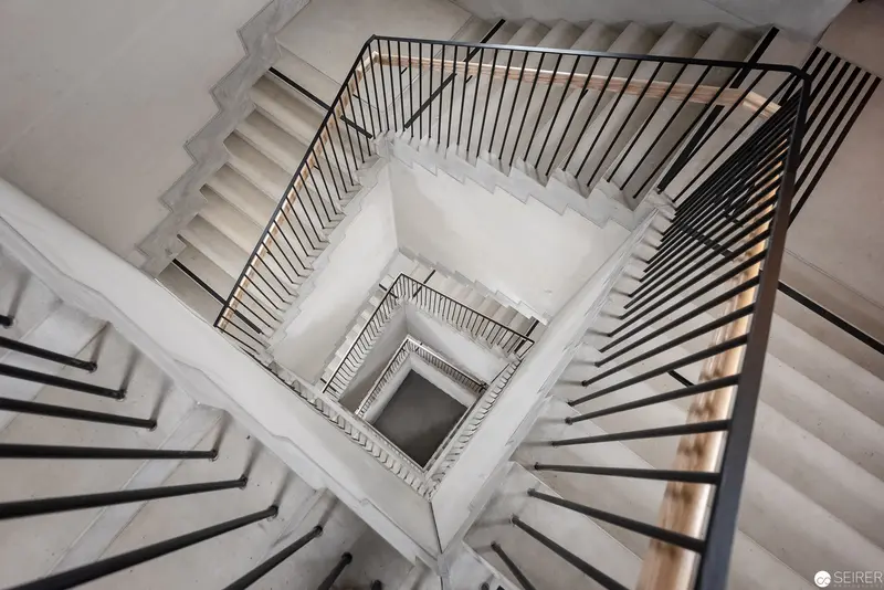 Geometric Descent: Monochromatic Stairwell Viewed from Above in Architectural Abstraction