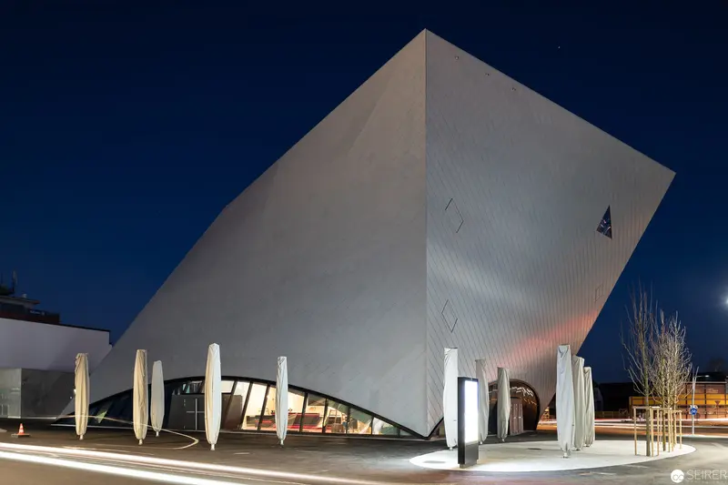 Modernist Angular Museum Building with Distinctive Geometric White Facade at Night