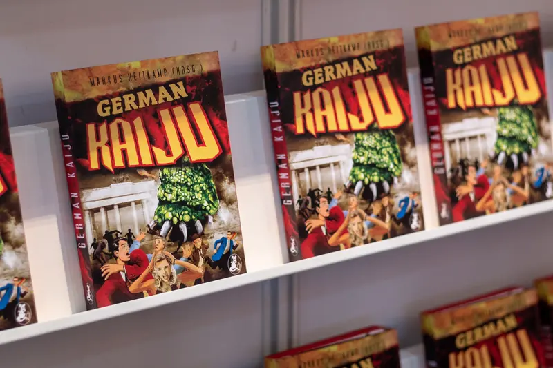 Multiple Book Covers Displaying "German Kaiju" Publication on Bookshelf Display