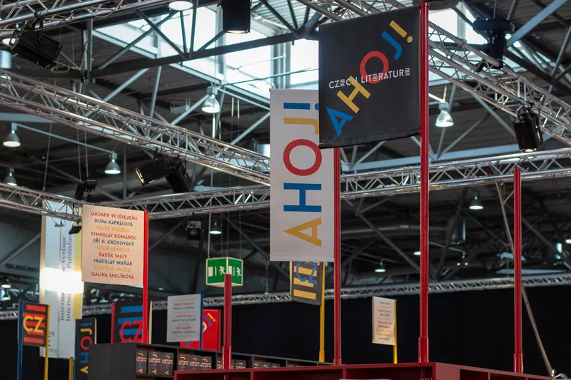Czech Literature Exhibition Signage with Geometric Vertical Banners in Industrial Space