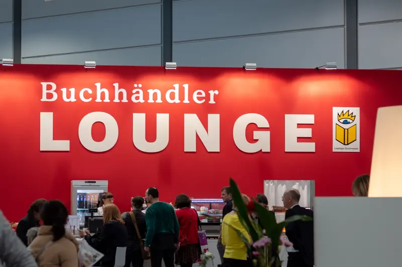 Buchländer Lounge Signage at Literary Event with Diverse Audience