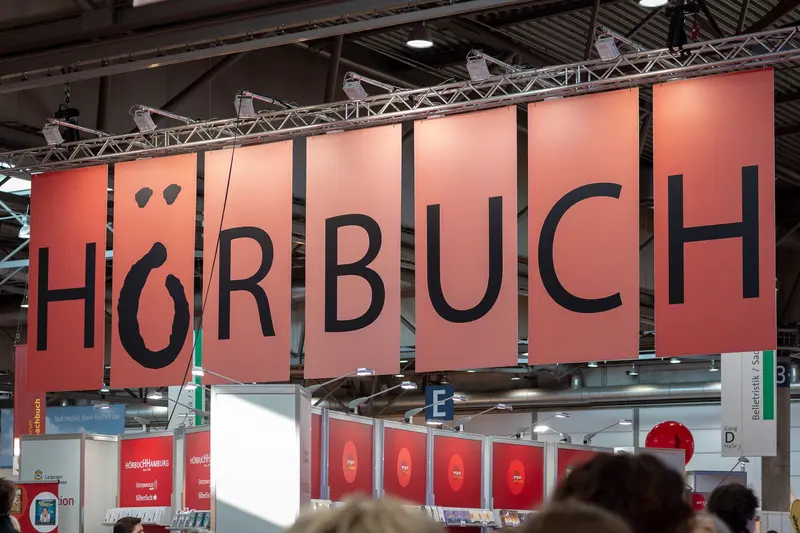 Large Red Signage Display of "HÖRBUCH" at Commercial Exhibition Space