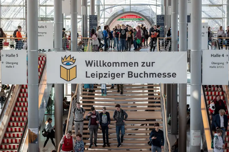 Visitors Navigate Stairs and Hallways at Leipzig Book Fair Entrance