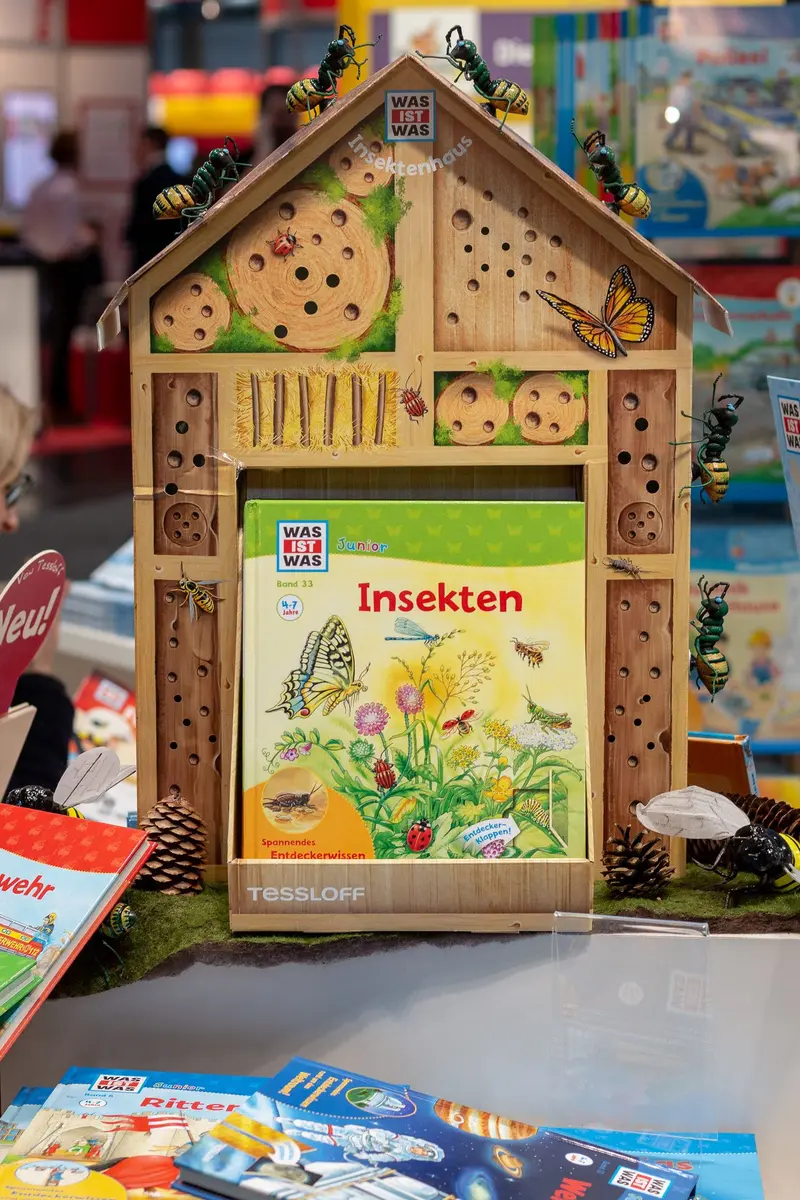 Wooden Insect Hotel with Educational Book Displaying Entomological Illustrations
