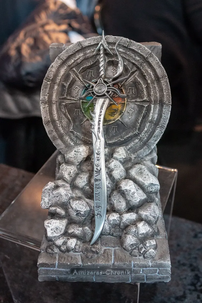 Ornate Medieval Sword and Wheel Sculpture with Symbolic Heraldic Elements