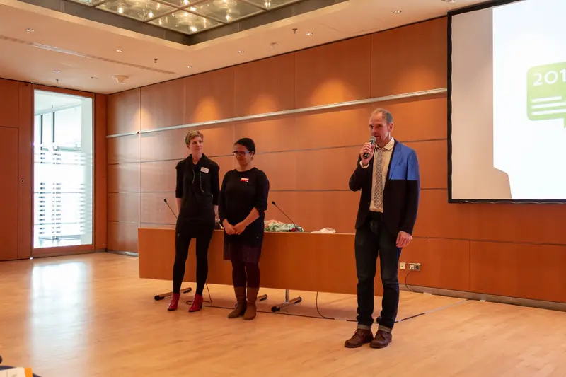 Corporate Presentation with Three Professionals in Modern Conference Room