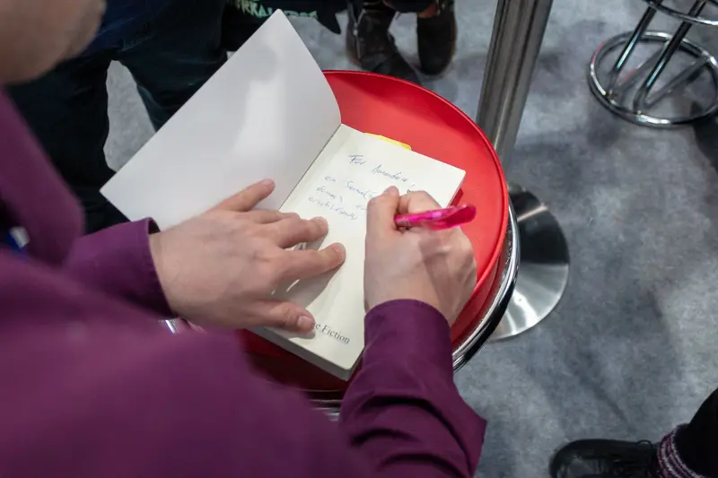 Hand Writing on Red Surface During Academic or Professional Workshop