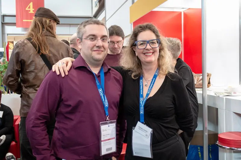 Conference Attendees Posing in Exhibition Space with Lanyard Badges
