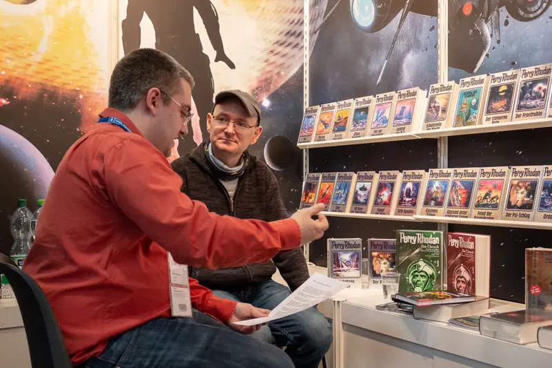 Science Fiction Book Collector Discussing Vintage Perry Rhodan Magazines
