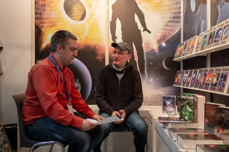 Comic Book Store Conversation: Two Men Discuss Graphic Novel Display