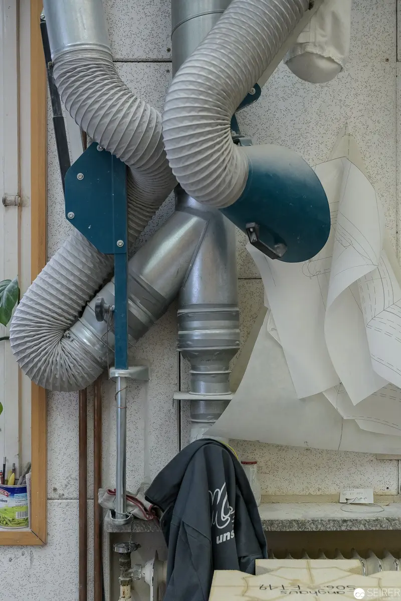Intricate Ventilation System with Flexible Ductwork in Workshop Setting