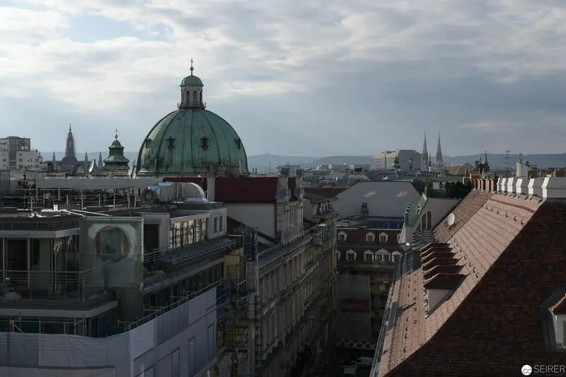 Verdant Green Dome Over Prague's Historic Rooftop Cityscape