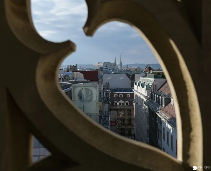 Gothic Cathedral Window Framing Architectural Cityscape of Intricate Urban Panorama