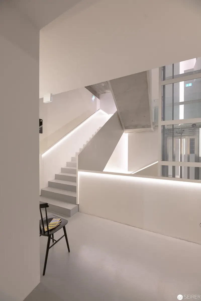 Minimalist Interior with Geometric Staircase and Isolated Chair