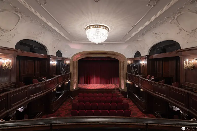 Ornate Private Theatre with Crystal Chandelier and Red Curtained Stage