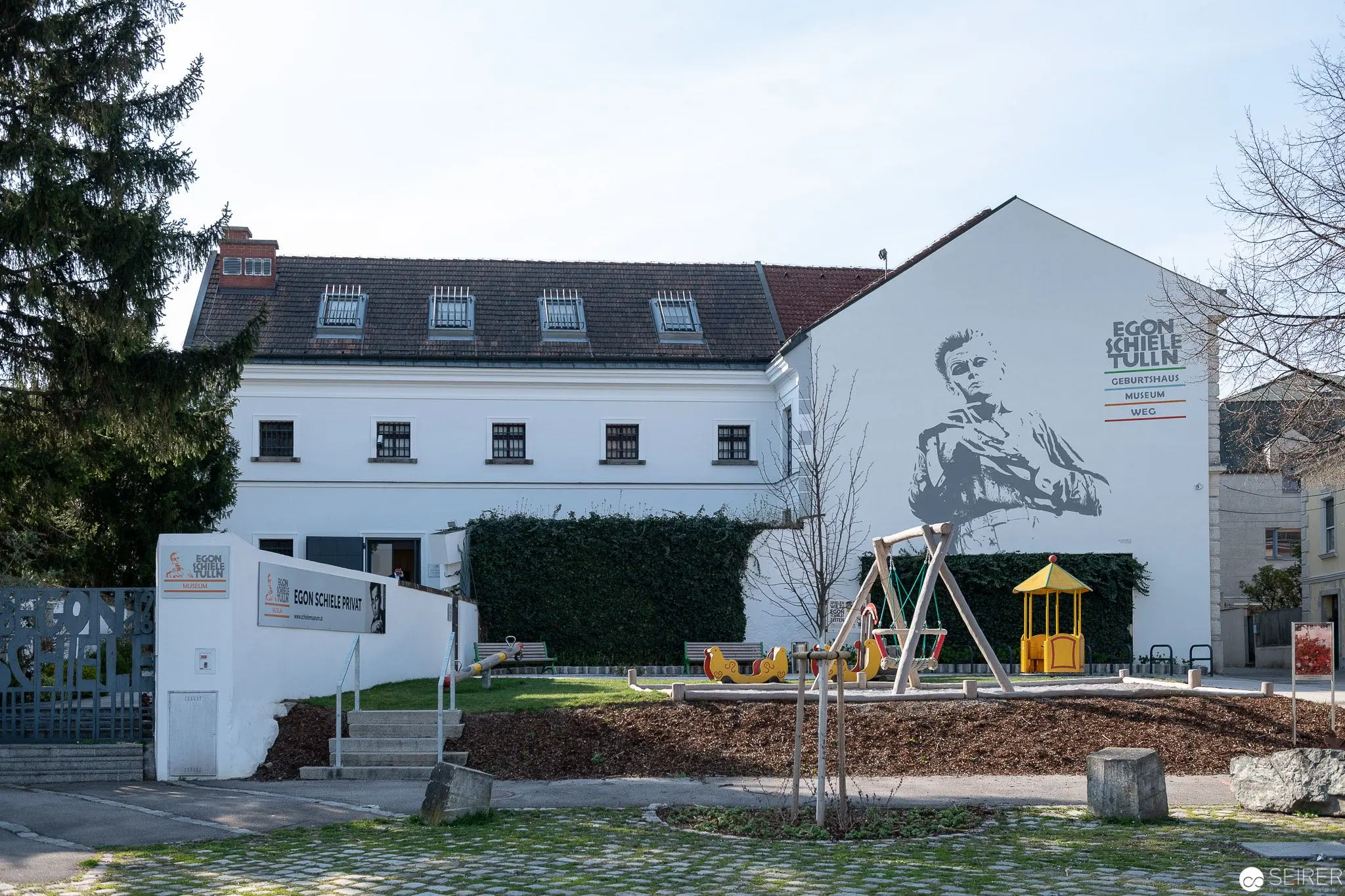 Egon Schiele Museum Exterior with Mural Portrait in Small Town Setting