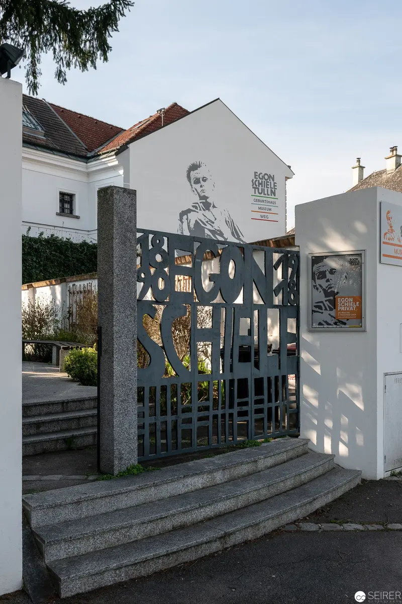 Memorial Gate with Decorative Metal Screening and Photographic Portraits