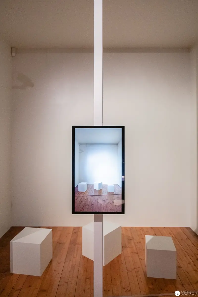 Minimalist Interior with Suspended Framed Reflection on White Vertical Plane