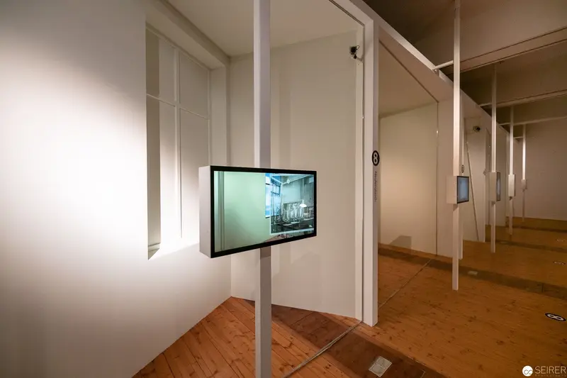 Multimedia Installation with Screen and Architectural Framing in White Gallery Space
