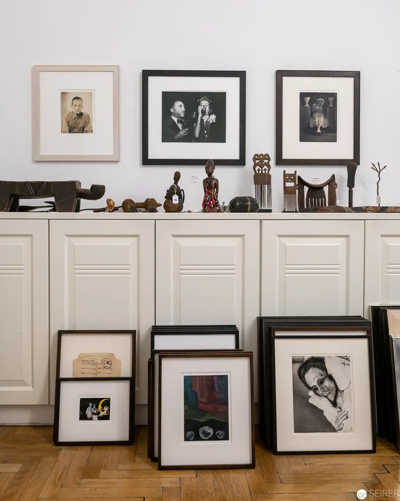 Gallery Wall Displaying Framed Vintage Photographs and Sculptural Objects