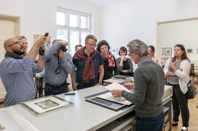 Art Scholars Examine Photographic Works During Collaborative Workshop Session
