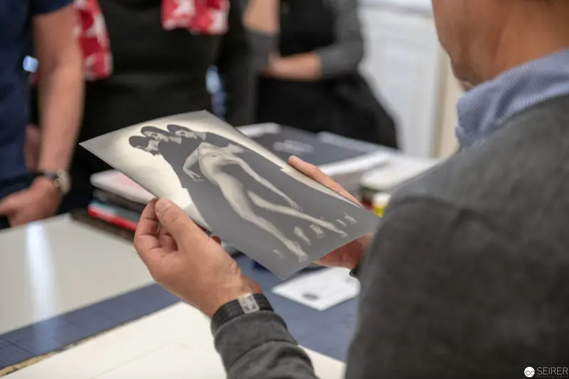 Archival Moment: Monochrome Photographic Print Examined by Researcher