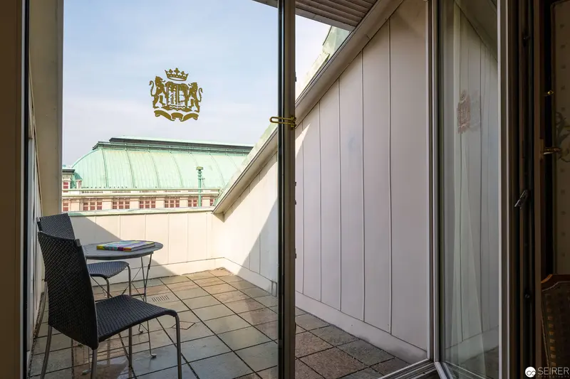 Hotel Bristol Wien: Minimalist Balcony with Heraldic Emblem and Architectural View