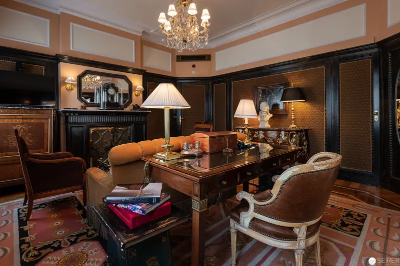 Luxurious Viennese Hotel Bristol Study with Elegant Wooden Furnishings and Crystal Chandelier