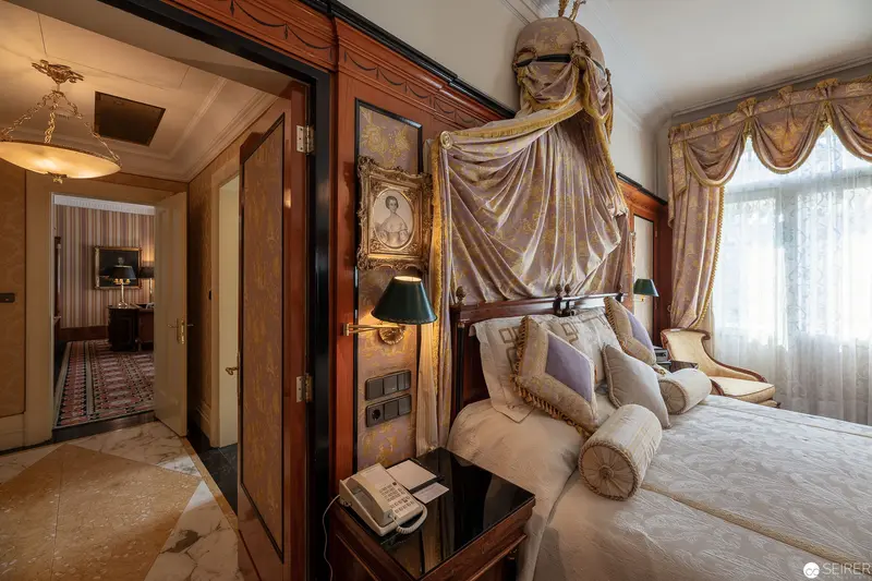 Opulent European Hotel Suite with Draped Canopy Bed and Elegant Interior Details